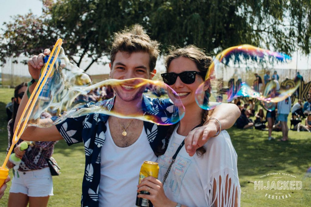 two people blowing giant bubbles